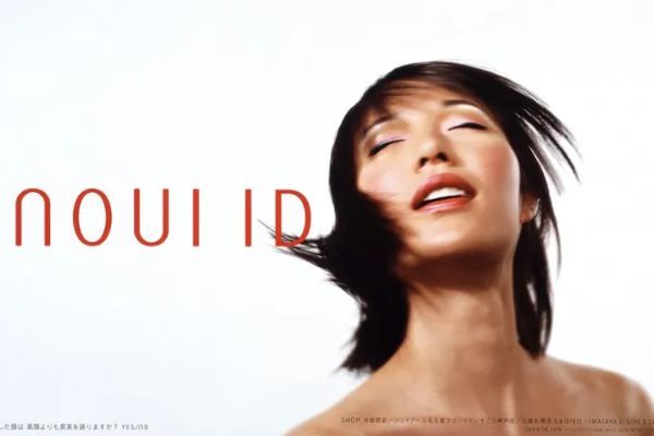 A pineapple covered in deep fried breading on a table in front of a person whose hands are on the table next to the pineapple